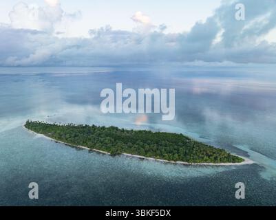 Ein ruhiger Sonnenuntergang erleuchtet eine idyllische Insel im Wakatobi-Nationalpark vor Sulawesi. Dies ist ein beliebtes Ziel für Taucher und Schnorchler. Stockfoto