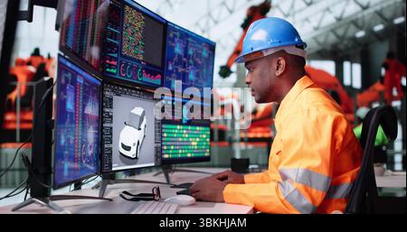 Junger Afroamerikanischer Ingenieur, Der Software Für Die Elektrische Montage In Der Automobilindustrie Entwickelt. Stockfoto