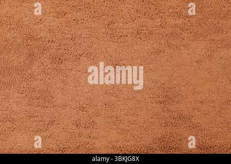 Struktur aus orangefarbenem Wildledergewebe mit abstrakter Shabby-Textur mit geprägten Farbnuancen in Großansicht, Makro. Polsterung, dekorative Stoffstruktur, Leinwand für Stockfoto