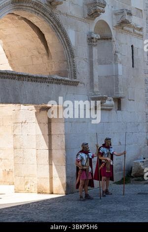SPLIT, KROATIEN, 08.06.2018: Zwei römische Soldaten in historischer Kleidung, darunter Helme und Umhänge, die Speere halten, sind vor einem alten s stationiert Stockfoto