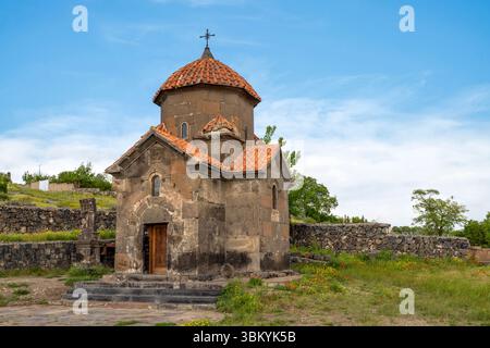 Die Karmravor-Kirche aus dem 7. Jahrhundert in Ashtarak, die wegen ihres intakten Ziegeldachs als „rötlich“ bekannt ist, ist eine kleine, wunderschön erhaltene kreuzförmige Kirche. Stockfoto