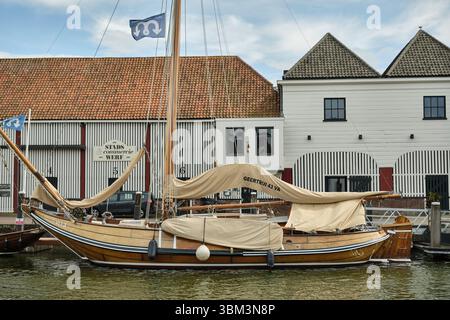26. Mai 2025 - Zierikzee-Niederlande: Klassisches Holzhoogaars-Segelboot Geertruij dockte vor der historischen Werft Stadstimmerwerf im Hafen an Stockfoto