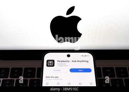 Perplexity AI-Auflistung auf dem Smartphone-Bildschirm mit vollständigem Apple-Logo im Hintergrund. Stafford, Großbritannien, 24. Juni 2025 Stockfoto