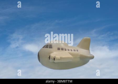 Spielzeugflugzeug fliegt durch den Himmel Urlaub Reise Frachtgut Transportkonzept mit Kopierraum. Stockfoto