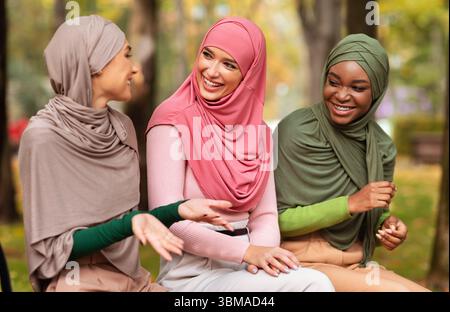 Drei Arabische Damen Sprechen Auf Der Bank Im City Park Sitzen Stockfoto