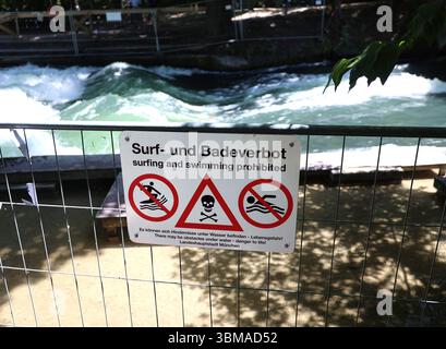 Ein Sommertag in der Landeshauptstadt München. Hier der Blick an der Eisbachwelle auf ein Absperrgitter mit einem Hinweisschild, Surf und Badeverbot *** Ein Sommertag in der Landeshauptstadt München hier der Blick auf die Eisbachwelle auf eine Barriere mit einem Schild, das Surfen und Schwimmen verbietet Stockfoto