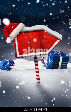 Flaches Pfeilschild, das bei Schnee auf einem Zuckerrohr steht, trägt Weihnachtsmütze, blaue Geschenke Stockfoto
