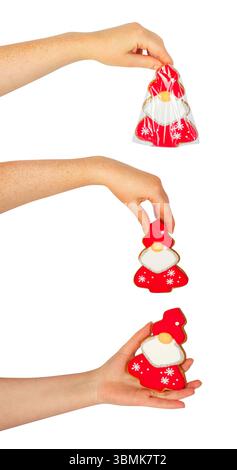 Isoliertes Foto der weiblichen Hand, die gepackte weihnachts- oder Neujahrskekse in Form des weihnachtsmanns auf weißem Hintergrund hält. Stockfoto