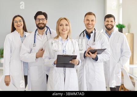 Glückliche medizinische Team-Gruppe, Chef und diverse Team von Ärzten, Praktikern, Chirurgen in Uniformen Stockfoto