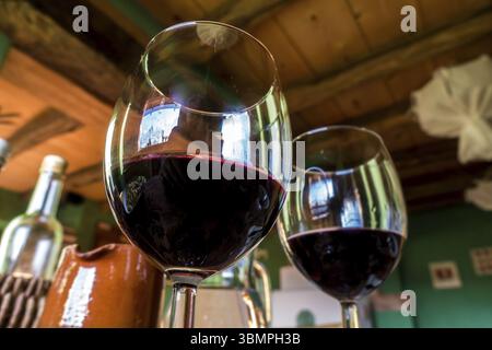 Glas Rotwein auf einem Tisch im rustikalen Restaurant Stockfoto