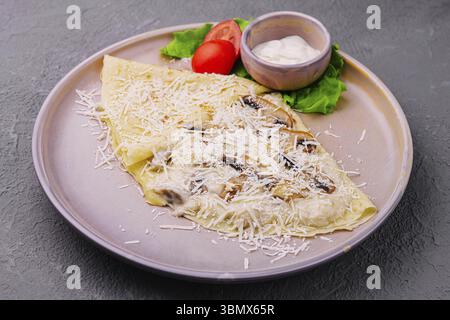 Stillleben, Pfannkuchen mit Pilzen und Parmesan auf Teller Stockfoto