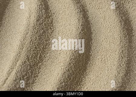 Makrohintergrund von trockener aktiver Hefe. Stockfoto