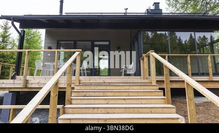 Moderne Holzsauna mit Treppen zum Wasser Stockfoto