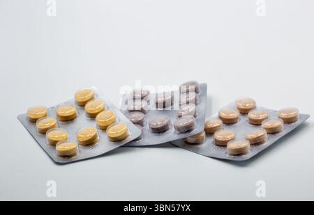 Bunte Pillen in Blisterpackungen Nahaufnahme auf weißem Hintergrund Stockfoto