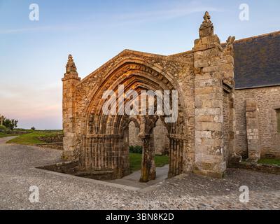 Gotische Veranda der Kapelle Notre-Dame-de-Grâce in der Pointe Saint-Mathieu, Bretagne, beleuchtet von warmem Sonnenuntergang. Stockfoto