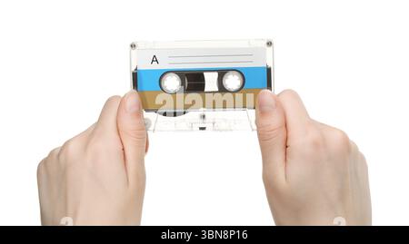 Frau mit Tonkassette mit leerem Etikett auf weißem Hintergrund, Nahaufnahme Stockfoto