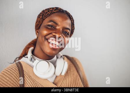 Porträt einer jungen glücklichen schwarzen Frau mit Zahnspangen. Sie schaut in die Kamera und lächelt. Stockfoto