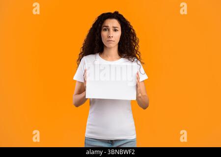 Traurige Frau Hält Leere Werbung Brett Über Gelben Hintergrund Stehen Stockfoto
