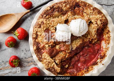 Erdbeer-Pflasterkuchen mit Eiscreme in Backform auf dem Tisch. Horizontale Draufsicht von oben Stockfoto