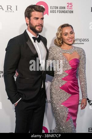 (DATEI) Miley Cyrus erhielt 2026 den Star auf dem Hollywood Walk of Fame. Miley Cyrus gehörte zu den 35 Preisträgern, die am Mittwoch, den 2. Juli 2025 von Eugenio Derbez und Richard Blade angekündigt wurden. WEST HOLLYWOOD, LOS ANGELES, KALIFORNIEN, USA - 4. MÄRZ: Der australische Schauspieler Liam Hemsworth trägt einen Burberry-Smoking und seine Freundin/amerikanische Sängerin, Songwriterin und Schauspielerin Miley Cyrus in einem doppelten rosa und funkelnden Moschino-Kleid kommen bei der 26. Jährlichen Elton John AIDS Foundation's Academy Awards Viewing Party, die am 4. März 2018 im City of West Hollywood Park in Los Angeles, Kalifornien stattfindet Stockfoto