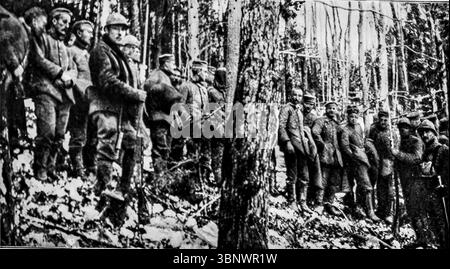 Deutsche Gefangene wurden Ende Dezember bei Hirzenstein während der letzten Schlachten um Hartmannswillerkopf, eine wichtige Bergfestung im Elsass, gefangen genommen. Das Bild zeigt erschöpfte Gefangene, die durch verschneite Waldgebiete in Richtung Hauptquartier der Division gebracht werden. Dies war Teil der heftigen Kämpfe zwischen französischen und deutschen Truppen in den Vogesen um die Kontrolle über den strategischen Gipfel. Stockfoto