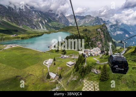 Der Trübsee oberhalb des Engelbergs ist ein malerischer Bergsee auf rund 1.800 Metern Höhe und ein beliebtes Ausflugsziel in der Region. Das Panorama rund um den Trübsee umfasst auch nahe Gipfel wie Titlis und Jochpass. Besucher genießen die Fahrt mit der Titlis-Seilbahn über den malerischen Trübsee in den Schweizer Alpen. Das Foto zeigt die beeindruckende Berglandschaft und die Seilbahnstation Schlächtismatt, Wolfenschiessen, Nidwalden, Schweiz und bietet einen atemberaubenden Blick auf die alpine Natur Stockfoto