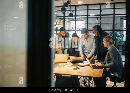 Geschäftsleute und Geschäftsleute arbeiten im Besprechungsraum im Büro zusammen Stockfoto