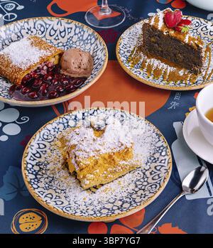 Essen, lebendige Auswahl verschiedener Desserts, serviert mit Eiskugeln auf einem dekorativen Tisch Stockfoto