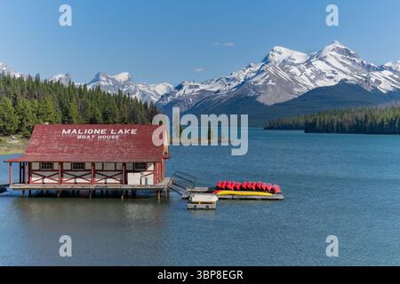 Maligne Lake Bootshaus mit schneebedeckten Bergen im Hintergrund, Jasper National Park, Alberta, Kanada Stockfoto