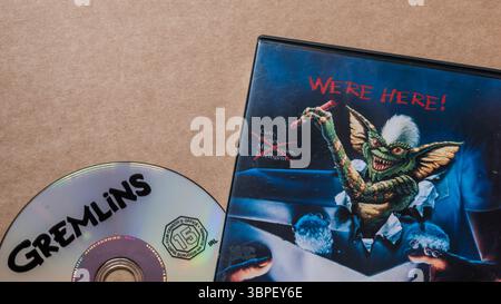 'Gremlins' DVD und Cover mit schlechtem Gremlin mit den Worten: 'We Are Here', isoliert auf hellem, einfachem Hintergrund, oberer Winkel aufgenommen Stockfoto