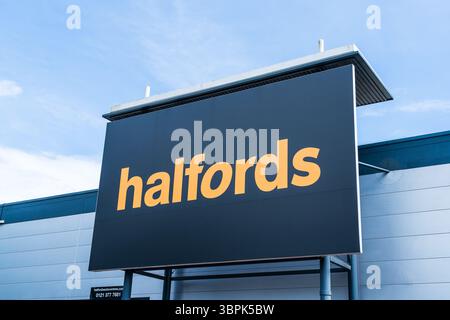 Erdington, Birmingham, Großbritannien – 4. Juli 2025: Externe Beschilderung von Halfords, einem britischen Hersteller von Motorausrüstung Stockfoto