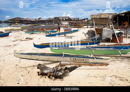20. April 2010, Mabul, Borneo, Malaysia: Insel Pulau Mabul in Sabah, Borneo, Ost-Malaysia. Boote ruhen am Sand auf der Insel Pulau Mabul, ein Paradies für Taucher und bewohnt von Zigeunern des Meeres. Mabul ist vor allem für seine Nähe zur Insel Sipadan (Malaysia) bekannt. Schulen von Tausenden von Barrakudas, gefolgt von Banken oder Fledermausfischen Carangidae; Dutzende von Büffelfischen; Riffhaie und eine endlose Parade von Schildkröten sind es, was in Sipadan steht; während Kapalai Mabul und Krötenfische oder Geisterpfeifen mit Hunderten von Stöcker, Jungplatax, Mandarinen oder Fritten abwechseln Stockfoto