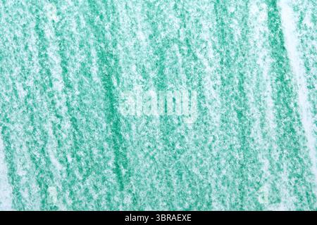 Kräftige grüne Pastellstriche füllen die strukturierte Oberfläche und zeigen Kunstfertigkeit. Stockfoto