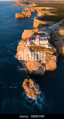 Aus der Vogelperspektive auf den zerklüfteten Klippen, geküsst vom goldenen Licht der untergehenden Sonne, Sagres, Faro, Portugal. Stockfoto