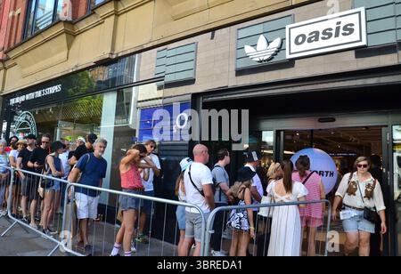 Manchester, Großbritannien, 12. Juli 2025 eifrige Oasis-Fans stehen in einem Geschäft in der Market Street, im Zentrum von Manchester, Großbritannien, für Oasis-Waren an. Die Stadt bereitet sich auf das zweite Oasis-Konzert am Samstag vor, an dem rund 70.000 Fans teilnehmen. Liam und Noel Gallagher geben insgesamt fünf Konzerte im Rahmen ihrer Oasis Live '25 Tour. Quelle: Terry Waller/Alamy Live News Stockfoto