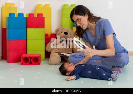 Kinderarzt zeigt visuelle Stimulationskarten für Neugeborenes in der Klinik Stockfoto
