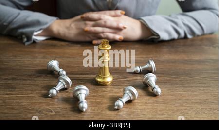 Schachführung Siegeskonzept mit Goldsieger Stand Alone mit gefallenen silbernen Schachfiguren König gewinnt das Spiel Entscheidung und Leistung Ziel Konzept Stockfoto