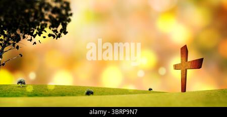 Das Holzkreuz steht in einem flachen, pastoralen Design-Feld mit einsamen Baumsträuchern und goldenem Bokeh-Hintergrund Stockfoto