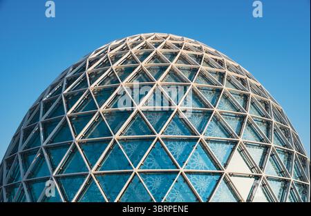 Nahaufnahme einer modernen geodätischen Glaskuppelstruktur vor klarem blauem Himmel, geometrische Muster in Stahl- und Glasarchitektur Stockfoto