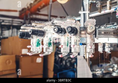 Gewindespanner befinden sich an den Schiebern der Maschinen. Industrieunternehmen zur Herstellung von Socken Stockfoto