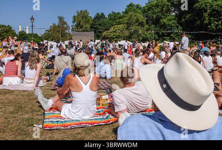 Zuschauer, die das Wimbledon Mens Tennis Final zwischen Jannik Sinner und Carlos Alcaraz auf einem großen Bildschirm im Battersea Park bei heißem Sonnenschein beobachten, London 13. Juli 2025 - : Credit Simon Dack Stockfoto