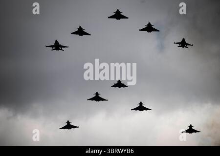 Ein Kampfflugzeug der französischen Luft- und Raumarmee Rafale B, zwei Kampfflugzeuge der französischen Luft- und Raumarmee Rafale C, ein Flugzeug der französischen Luft- und Raumarmee Mirage 2000-5F, ein Kampfflugzeug der belgischen Luftwaffe F16, ein Kampfflugzeug der Schweizer Luftwaffe F18, ein Eurofighter Typhoon, Ejercito del Aire (britische Luftwaffe), ein Luftwaffe), ein Luftwaffe (britische Luftwaffe) Eurofighter Typhoon-Flugzeuge und ein Aeronautica Militare (italienische Luftwaffe) Eurofighter Typhoon-Flugzeuge führen während der einen Überflug durch Stockfoto