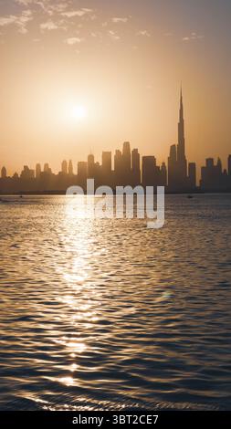 Sonnenuntergang über der Skyline von Dubai mit dramatischer Beleuchtung, perfekte Kulisse für Immobilienaktionen und Stadtplakate Stockfoto