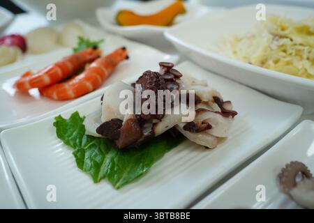 Verschiedene Meeresfrüchte-Platten mit Oktopus auf weißen Tellern Stockfoto