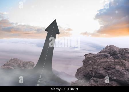 Der Straßenpfeil, der vom felsigen Plateau aufsteigt, schneidet durch den wirbelnden Nebel unter dem Sonnenaufgangshimmel, Kopierraum Stockfoto