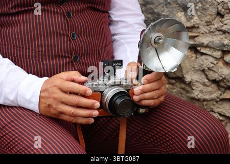 Nahaufnahme einer alten Nikon-Kamera in den Händen des Fotografen. Darstellung des Chirche-Traditionen-Tages. Stockfoto