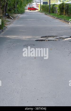 Zerstörte Asphalt der Straße, Stadt Fotografie im Sommer an einem sonnigen Tag close-up Stockfoto