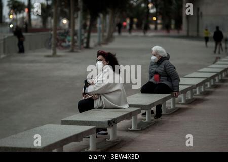 6. November 2020, Barcelona, Katalonien, Spanien: Zwei Frauen mit Gesichtsmasken sitzen auf der Promenade von Barcelona auf das Meer. Coronavirus-Ausbruch zweite Welle in Spanien kam es in der letzten Woche zu covid-Todesfällen bei 1.002, und die Infektionsrate beginnt sich zu verlangsamen. (Bild: © Jordi Boixareu/ZUMA Wire) Stockfoto