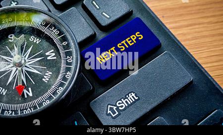 Schaltfläche „nächste Schritte“ auf der Tastatur mit Kompass Stockfoto