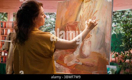 Handwerklich inspiriert von natürlichen ländlichen Elementen, um ein Meisterwerk mit modernen Pinseln im Kunststudio auf Leinwand zu malen. Arbeiten mit Motivation und Kreativität für den kreativen Prozess der bildenden Kunst. Kamera B.. Stockfoto